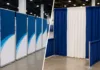 Partition Banner Stands vs Pipe and Drape display setup at a professional trade show exhibition